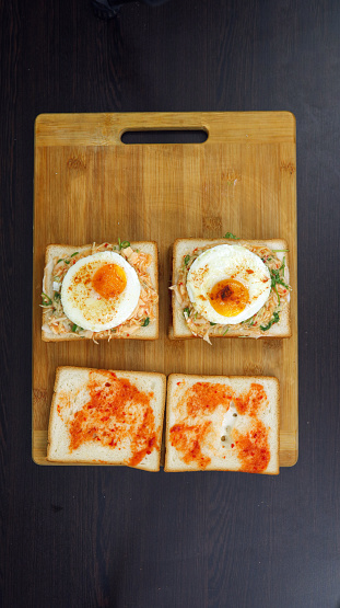 A Golden-Yolk Fried Egg Sandwich on Toast for a Delightfully Savory Breakfast. Designed to Elevate Your Morning Rituals with Delightfully Savory Flavor and Nourishing Satisfaction