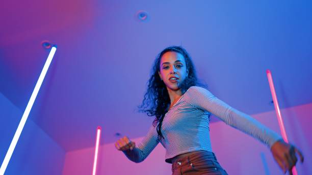 istock Low angle camera of hispanic dancer looking at camera and dancing. Regalement. 2151299001