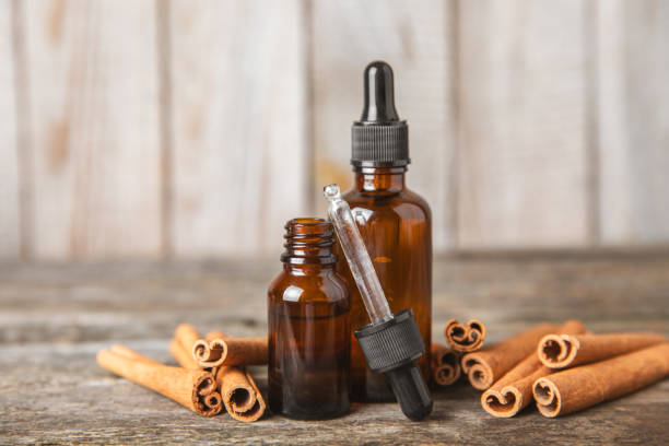 istock Cinnamon aromatic essential oil and cinnamon sticks  on background. Aromatherapy. Organic cosmetic oil. Spa concept. 2151301168
