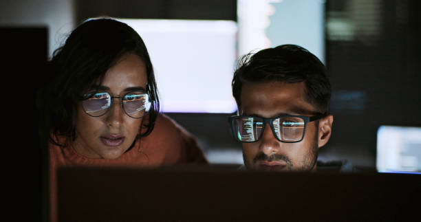 Hispanic Latin American couple, software engineer developer use computer, work on program coding together at home office. Programming language development technology, freelance job at night concept Hispanic Latin American couple, software engineer developer use computer, work on program coding together at home office. Programming language development technology, freelance job at night concept software development planning stock pictures, royalty-free photos & images