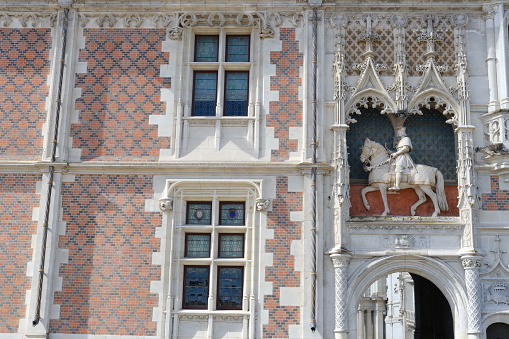 Blois, France - March 27, 2024: a tight frame of the facade of the Blois castle.