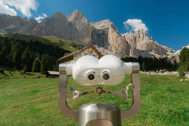 Coin-operated binocular in Dolomites in summer with view of pinnacle mountains