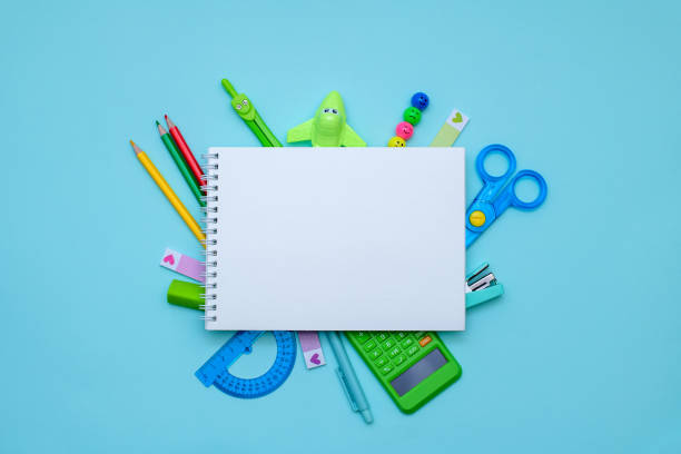 istock Back to school concept. Open notebook with school supplies, office. Copyspace. 2151314922