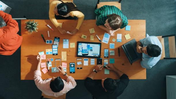 istock Top view of developer team working together to stick idea on board. Convocation. 2151315779