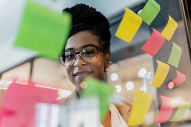 istock Businesswoman planning and having ideas looking at post it at office 2151315847