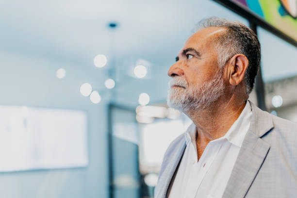 istock Senior businessman looking away at office 2151316652