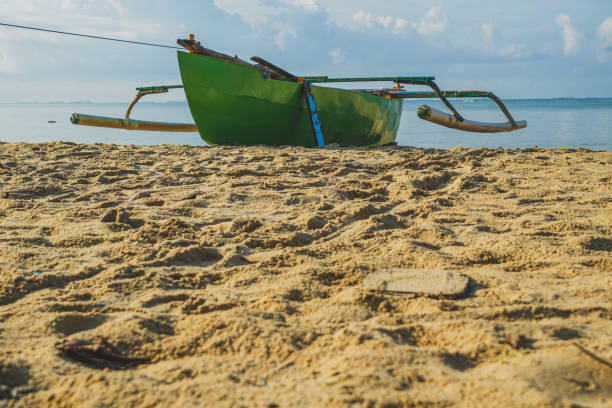 istock Small green boat  Resting on the shore 2151322849