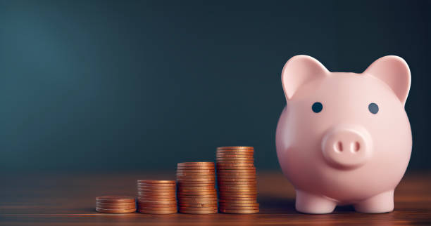 istock Piggy bank with coins - copy space 2151325166