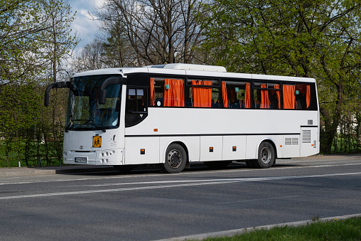 Zakopane, Poland - 27th April, 2024: White intercity school bus Autosan Eurolider 9 on a public parking. This model is a popular bus in Poland.