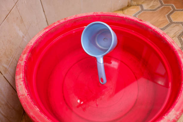istock A blue dipper in the water in a red container in the bathroom 2151332780