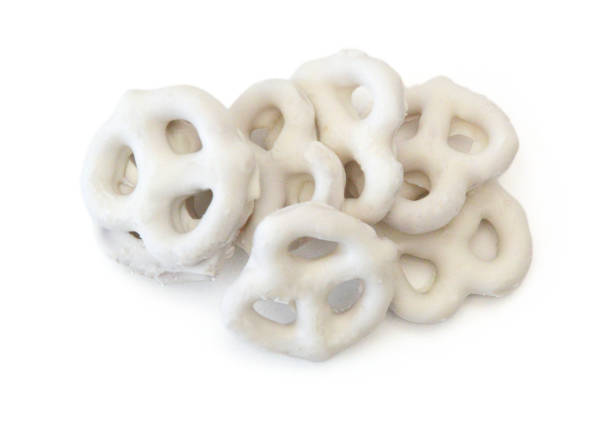 White chocolate covered pretzels on white background