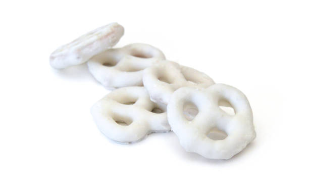 istock White chocolate covered pretzels on white background 2151332839