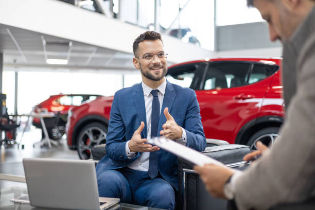 istock Car dealer explaining details to potential buyer 2151337964