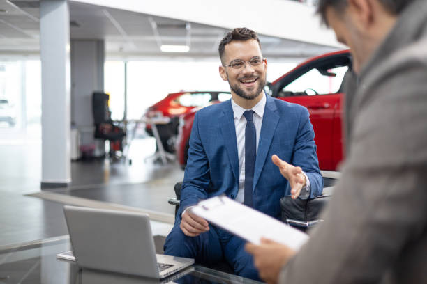 istock Professional car salesman discussing with a client 2151337997