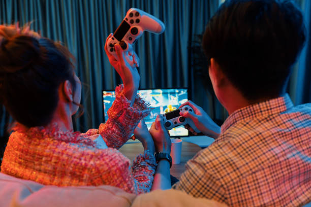 istock Couple controlling joystick playing fighting competition game on tv. Infobahn. 2151348911