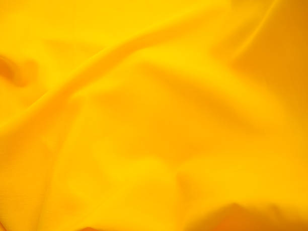 istock Yellow Background Cloth Fabric Orange Color Gradient Texture Pattern Silk Wave Banner Gold, Fashion Material Backdrop Poster for Summer Tropical Travel Holidays, Satin Mockup Luxury Premium. 2151354289