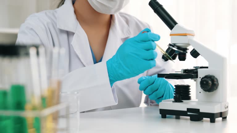 Laboratory researcher develop new medicine using colorful chemical. Rigid.