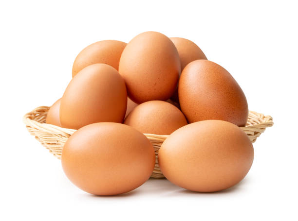 istock Front view of chicken eggs in stack in wicker basket isolated on white background with clipping path 2151356190