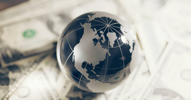 istock Glass globe and money 2151358379