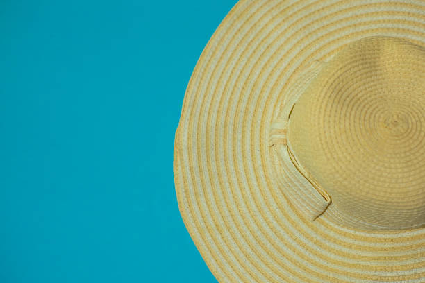 Hat with bow on a blue background. Summer concept. Background for layouts and advertising.