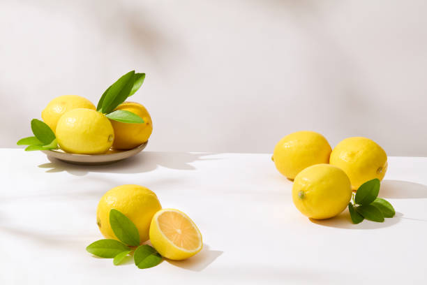 istock Fresh yellow lemons neatly arranged on white table with blank space for displaying product of natural ingredient. Front view photo for advertising or designing 2151361752