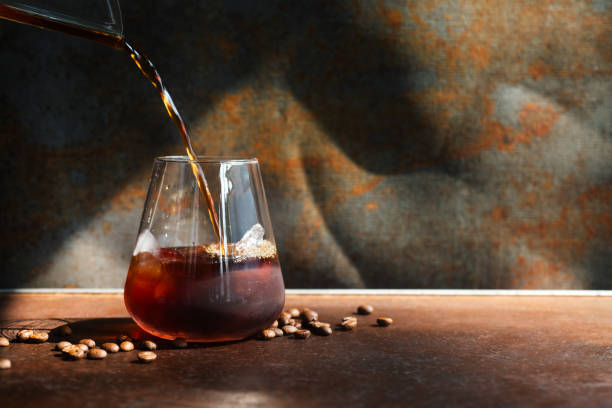 homemade cold cold brew coffee pouring into glass.