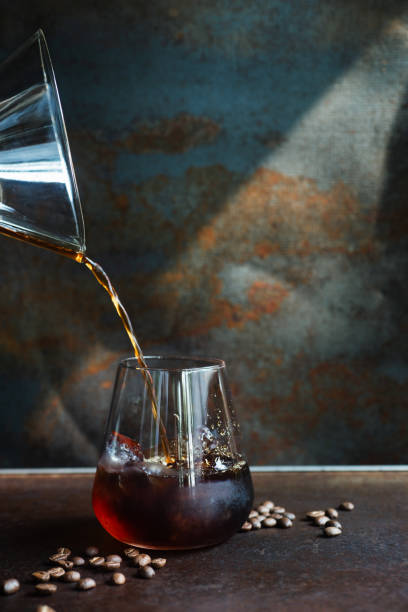 istock homemade cold cold brew coffee pouring into glass. 2151364507