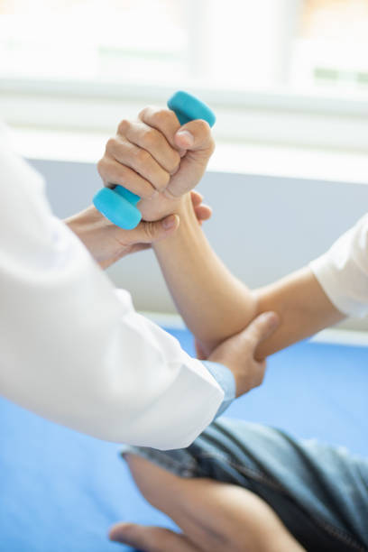 istock doctor is checking for muscle injuries and using dumbbells test injury and also help with physical therapy strengthen muscles because physical therapy will help strengthen muscles and help blood flow 2151364858