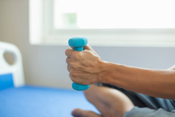 istock doctor is checking for muscle injuries and using dumbbells test injury and also help with physical therapy strengthen muscles because physical therapy will help strengthen muscles and help blood flow 2151364859
