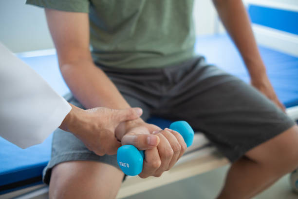 istock doctor is checking for muscle injuries and using dumbbells test injury and also help with physical therapy strengthen muscles because physical therapy will help strengthen muscles and help blood flow 2151364941
