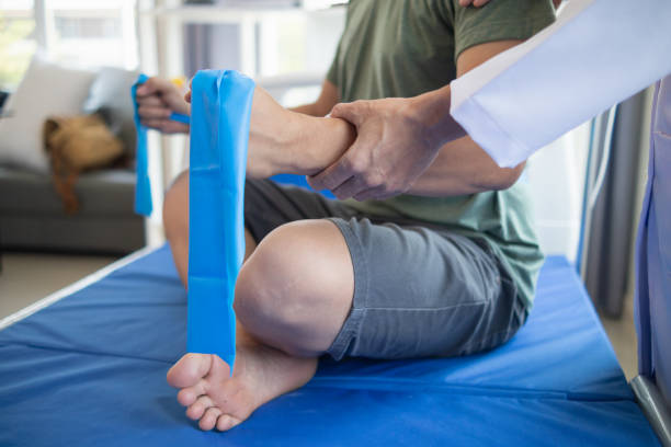 istock doctor is examining muscle injury and using elastic bands test injury and also help with physical therapy strengthen muscles because physical therapy will help strengthen muscles and help blood flow. 2151364946