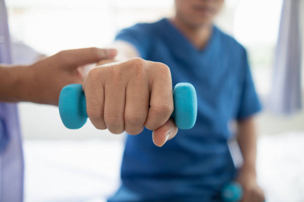 istock doctor is checking for muscle injuries and using dumbbells test injury and also help with physical therapy strengthen muscles because physical therapy will help strengthen muscles and help blood flow 2151365015