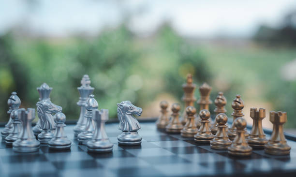 istock gold  knight Against whithe background, International chess, ideas and competition and strategy, chess board game competition business concept. 2151365248