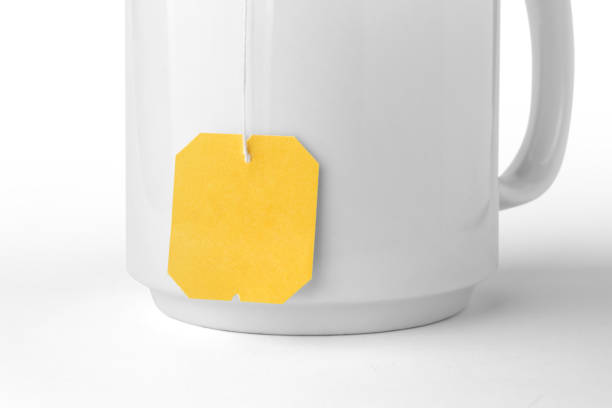istock Close up of white ceramic mug with teabag label isolated on a white background 2151367964