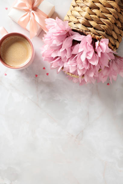 istock Flat composition with a cup of coffee, flower basket, gift box on a stone table. Happy Mothers Day, birthday, International Womens Day concept. 2151368007