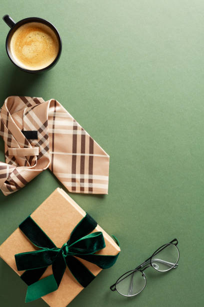 istock Happy Fathers Day concept. Flat lay composition with gift box, tie, coffee cup, glasses on dark green background. 2151368799