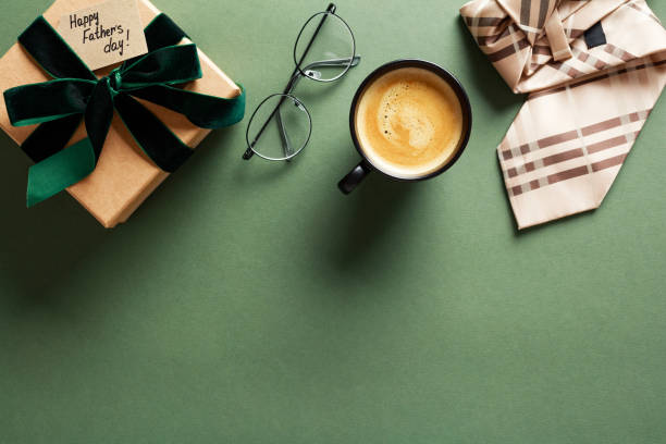 istock Happy Fathers Day flat lay composition with gift box, glasses, coffee cup, tie on dark green table. 2151368942