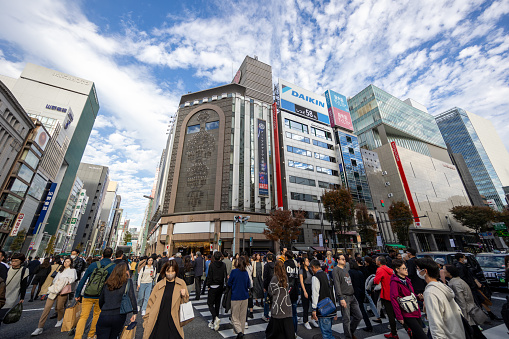Tokyo, Japan - November 23, 2023 : Pedestrians at the Ginza 4-Chome in Tokyo, Japan. Ginza is a popular upscale shopping area of Tokyo.