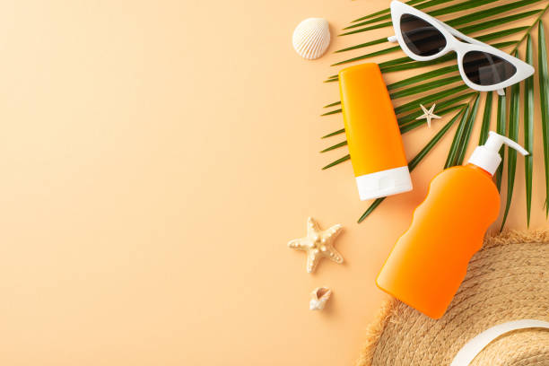 istock Beach accessories layout on beige background featuring sunblock, sunglasses, and palm leaves effectively communicating sun safety and vacation vibes 2151372320