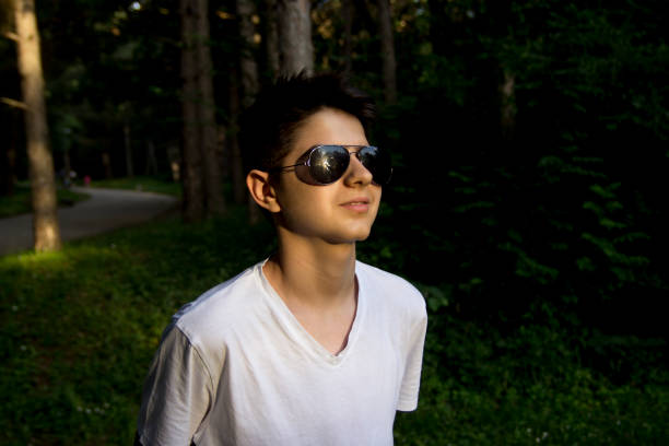 Caucasian teenager boy smiling outdoors in park