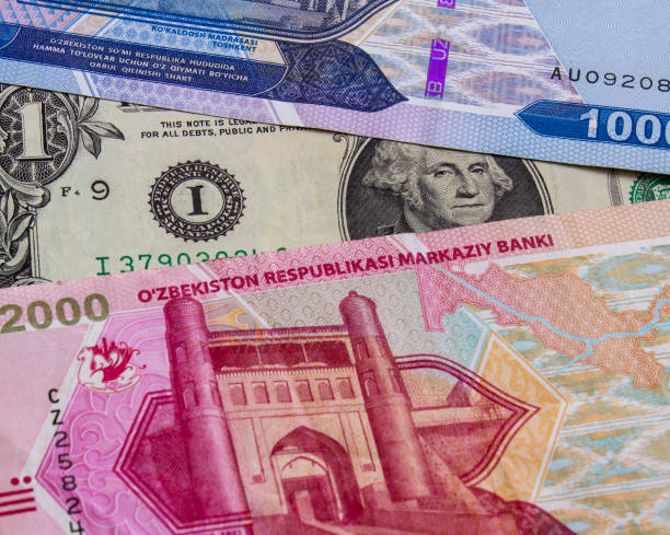 istock Uzbekistani sum and US dollar banknotes 2151373897