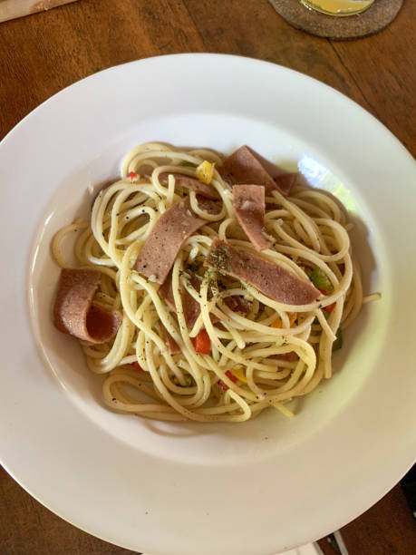 istock a pasta with ham and peppers in a white bowl 2151376391