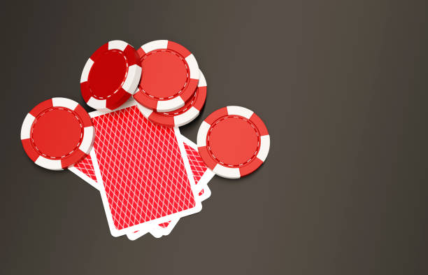 Red dice and chips on a black table in a poker room or casino. A high winning combination of two sixes in a game of craps or dice.