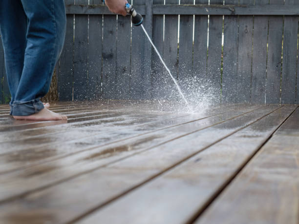 istock Hand holding a pressure sprayer, cleaning wooden deck. 2151381626