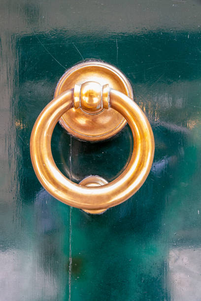 Old metal door knocker on wooden door