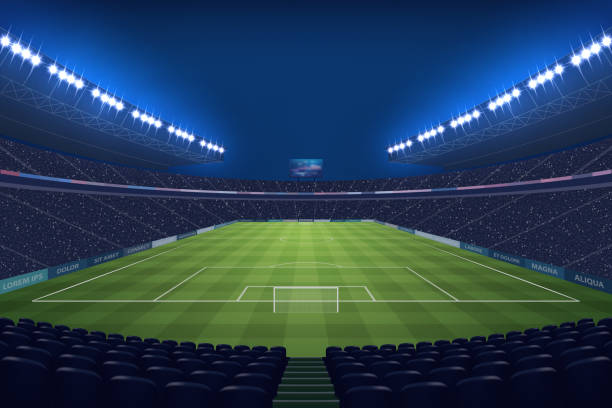 istock Modern Soccer Stadium Illuminated by Floodlights at Night 2151382339