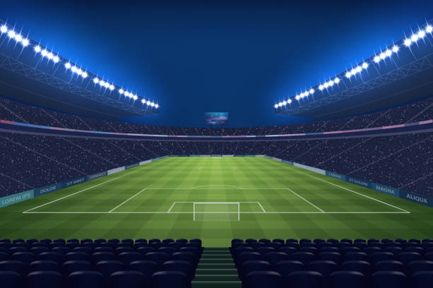 istock Modern Soccer Stadium Illuminated by Floodlights at Night 2151382340