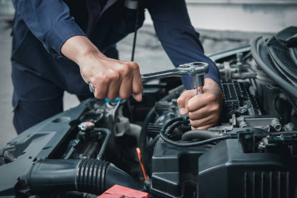 istock Mechanic using wrench while working on car engine outside the service center , Repair and service. 2151384264
