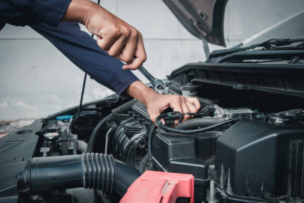 istock Mechanic using wrench while working on car engine outside the service center , Repair and service. 2151384278