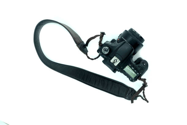 istock Black digital SLR camera in a white background 2151384881